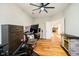 Multi-purpose room featuring wood flooring, ceiling fan, and exercise bike at 7158 Sugar Maple Ln, Brownsburg, IN 46112