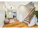Inviting foyer with wood floors, wainscoting, staircase and ample natural light at 7158 Sugar Maple Ln, Brownsburg, IN 46112