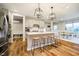 Modern kitchen with a large island, stainless steel appliances, and stylish lighting at 7158 Sugar Maple Ln, Brownsburg, IN 46112