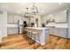 Bright kitchen features stainless appliances, white countertops and a large island with barstool seating at 7158 Sugar Maple Ln, Brownsburg, IN 46112