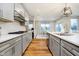 Kitchen with stainless steel appliances, white countertops and an open concept leading into the dining area at 7158 Sugar Maple Ln, Brownsburg, IN 46112