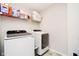 Laundry room featuring new front load washer and dryer and wire rack shelving at 7158 Sugar Maple Ln, Brownsburg, IN 46112