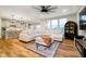 Bright and open living room with large windows, modern furniture, and wood floors at 7158 Sugar Maple Ln, Brownsburg, IN 46112