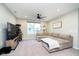 Comfortable living room featuring a large sectional, ceiling fan, natural light, and an entertainment center at 7158 Sugar Maple Ln, Brownsburg, IN 46112