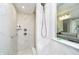Shower featuring marble tiling, rainfall shower head, and glass door at 7158 Sugar Maple Ln, Brownsburg, IN 46112