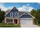 Charming two-story home with blue siding, brick accents, and a welcoming front porch at 7288 Broadview Ln, McCordsville, IN 46055