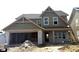 New two-story home featuring brick accents, attached two-car garage, and coordinated neutral siding at 7288 Broadview Ln, McCordsville, IN 46055