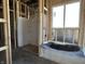 Modern bathroom featuring a shower stall, and bathtub, illuminated by a window, awaiting final finishes at 778 Oakleaf Dr, Greenfield, IN 46140