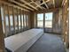 Bright bedroom featuring a stack of drywall, framed walls, and multiple windows, offering ample natural light at 778 Oakleaf Dr, Greenfield, IN 46140