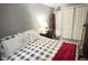 Relaxing bedroom with a gray and white patterned bedspread and gray walls at 8006 Sunfield Ct, Indianapolis, IN 46214