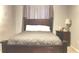 A cozy bedroom offers a large bed, soft lighting, and a calming color scheme at 8006 Sunfield Ct, Indianapolis, IN 46214