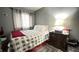 Comfortable bedroom with a gray and white patterned bedspread and gray walls and curtains at 8006 Sunfield Ct, Indianapolis, IN 46214