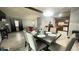 A dining room features a table with decor and chairs, an overhead light, and access to the kitchen and living room at 8006 Sunfield Ct, Indianapolis, IN 46214
