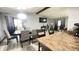 The dining room is complete with a contemporary chandelier, a table, and open to other areas of the home at 8006 Sunfield Ct, Indianapolis, IN 46214