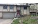 Two story home featuring a stone facade, attached garage, and elevated deck at 8006 Sunfield Ct, Indianapolis, IN 46214
