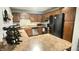 The kitchen is complete with wood cabinets, stainless appliances, and an island at 8006 Sunfield Ct, Indianapolis, IN 46214