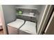 Efficient laundry area with a washer, dryer and shelving for storage at 8006 Sunfield Ct, Indianapolis, IN 46214