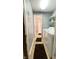 Convenient laundry area with washer, dryer, shelving, and access to the bathroom at 8006 Sunfield Ct, Indianapolis, IN 46214