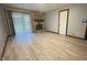 Cozy living room with a stone fireplace, wood floors, and a sliding glass door at 8006 Sunfield Ct, Indianapolis, IN 46214