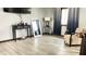 A living room with a console table, modern flooring, and large windows with two-tone curtains at 8006 Sunfield Ct, Indianapolis, IN 46214