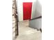 Modern staircase leading to a door with a red finish at 8006 Sunfield Ct, Indianapolis, IN 46214