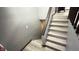 Bright stairway features gray walls, white risers and wooden handrail at 8006 Sunfield Ct, Indianapolis, IN 46214