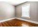 Cozy room with hardwood floors, neutral walls, and a bright window with blinds at 801 N Pennsylvania St # Apt D, Indianapolis, IN 46204