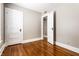 Empty bedroom featuring hardwood floors, neutral walls, and two doors at 801 N Pennsylvania St # Apt D, Indianapolis, IN 46204