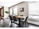 Bright dining room featuring modern decor, gray chairs, a light wood table, and ample natural light from the windows at 801 N Pennsylvania St # Apt D, Indianapolis, IN 46204