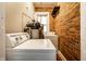Functional laundry room featuring exposed brick and modern washer and dryer at 801 N Pennsylvania St # Apt D, Indianapolis, IN 46204