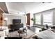 Contemporary living room with exposed brick accents, sleek furniture, and large windows offering a bright and airy ambiance at 801 N Pennsylvania St # Apt D, Indianapolis, IN 46204