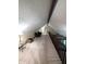 The finished attic has carpet, wood railings, and furnishings along one wall at 8017 Dogwood Ct, Plainfield, IN 46168