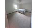 This cozy bedroom features neutral walls and carpet, a ceiling fan, and a bright window at 8017 Dogwood Ct, Plainfield, IN 46168