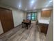 Dining area features wood-look flooring, natural lighting, and a view to the outside at 8017 Dogwood Ct, Plainfield, IN 46168