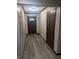 Inviting entryway with wood-look flooring and decorative wood door at 8017 Dogwood Ct, Plainfield, IN 46168