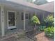 Inviting front porch with brick accents, columns, and a well-maintained garden at 8017 Dogwood Ct, Plainfield, IN 46168