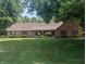 Charming single-story brick home featuring lush green lawn and mature trees at 8017 Dogwood Ct, Plainfield, IN 46168