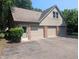 Spacious three-car garage featuring brick accents and ample parking space at 8017 Dogwood Ct, Plainfield, IN 46168