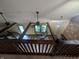 The living room viewed from above has exposed beams and a comfortable chair near a window at 8017 Dogwood Ct, Plainfield, IN 46168
