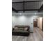 Comfortable living room with sofa, recessed lights, wood floors, and a decorative wood door at 8017 Dogwood Ct, Plainfield, IN 46168