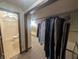 Walk-in closet features clothing racks and view to the bathroom with tiled floors at 8017 Dogwood Ct, Plainfield, IN 46168