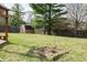 Backyard with a shed is surrounded by trees and greenery, offering a peaceful outdoor setting at 8122 Tanager Ct, Indianapolis, IN 46256