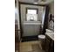Bathroom features a washer and dryer, vanity sink, toilet, and window with natural light at 8122 Tanager Ct, Indianapolis, IN 46256