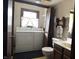 Bathroom features a washer, dryer, vanity sink, toilet, and window offering natural light at 8122 Tanager Ct, Indianapolis, IN 46256