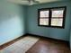 Bedroom with wood and tile flooring and a window that offers backyard views at 8122 Tanager Ct, Indianapolis, IN 46256