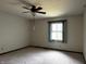 Bedroom featuring a ceiling fan, carpeted floors, and a window at 8122 Tanager Ct, Indianapolis, IN 46256