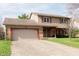 View of a two-story home featuring a brick and siding exterior and a two-car garage at 8122 Tanager Ct, Indianapolis, IN 46256