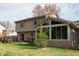 Exterior view showcases a wood deck and sunroom extending from a two-story home at 8122 Tanager Ct, Indianapolis, IN 46256