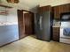 Cozy kitchen showcases wood cabinets, stainless steel refrigerator, and a view into another room at 8122 Tanager Ct, Indianapolis, IN 46256