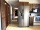 Traditional kitchen featuring stainless steel refrigerator with a view into other parts of the home at 8122 Tanager Ct, Indianapolis, IN 46256